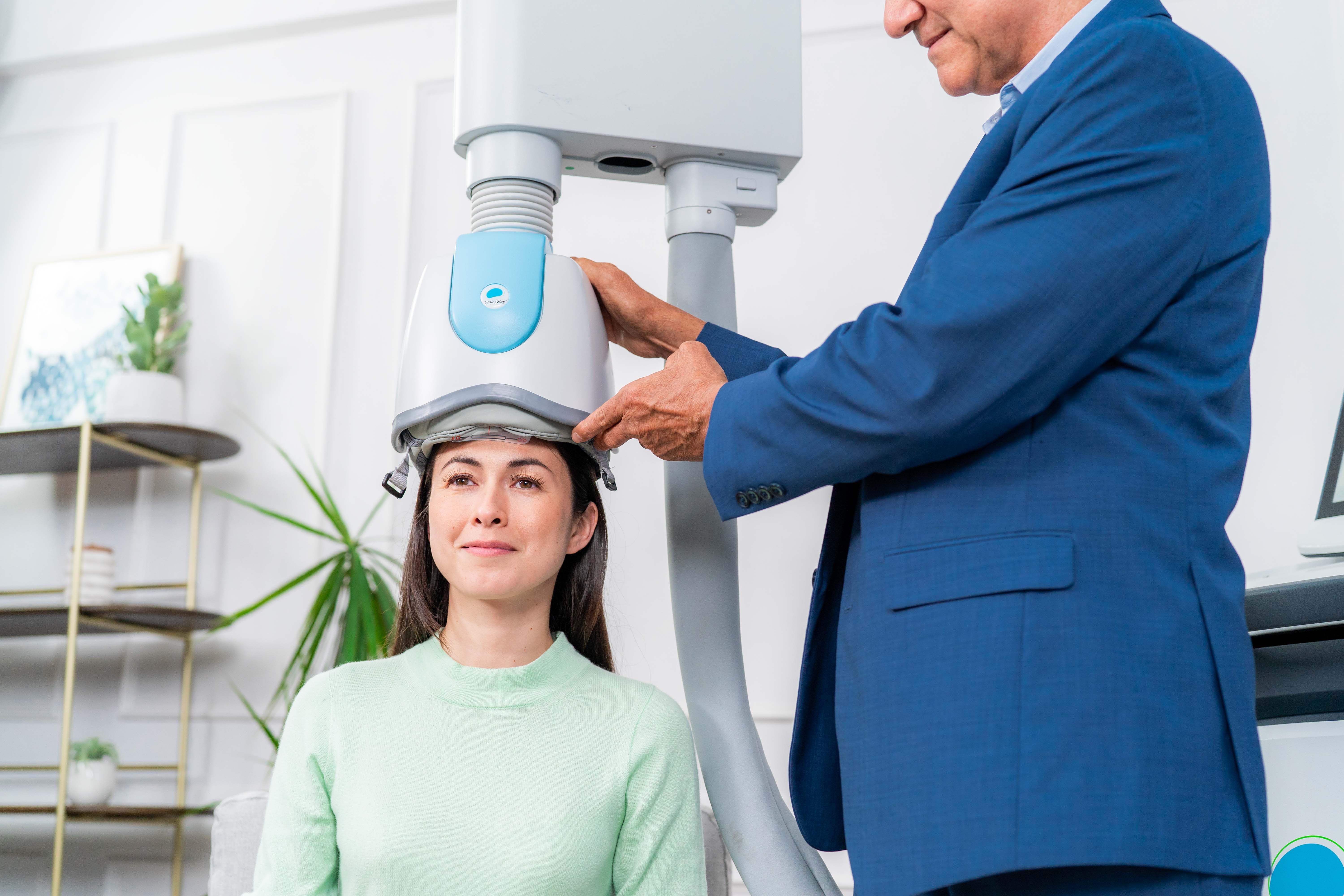 Patient being fitted with the blue dTMS helmet